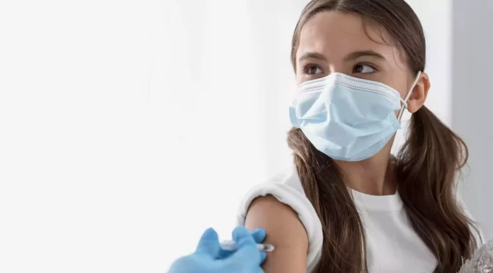 doctor-vaccinating-little-girl-with-copy-space