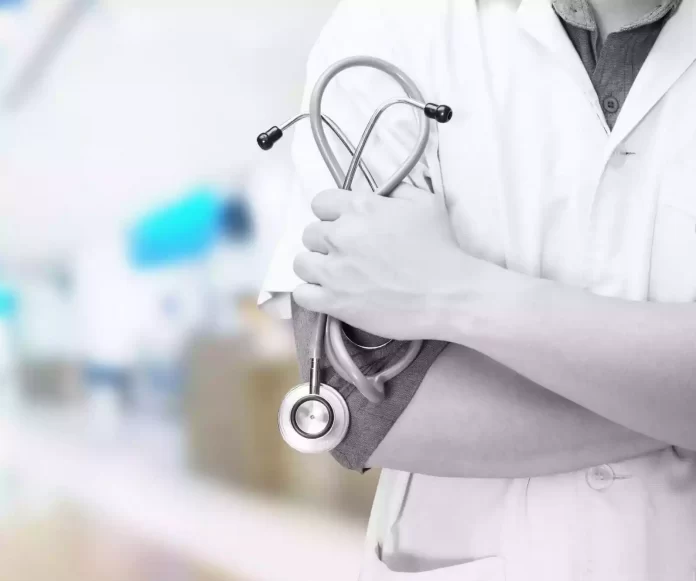 doctor-with-stethoscope-in-the-hands-and-hospital-background